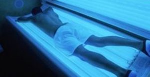 a man laying on a sunbed face down