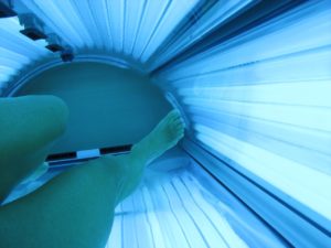 a ladies legs getting a tan on a sunbed