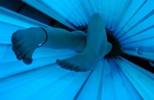 a sunbed that is switched on with a woman using it